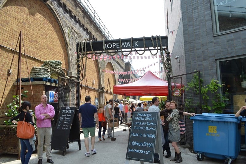 the entrance to the busy maltby street food market in london