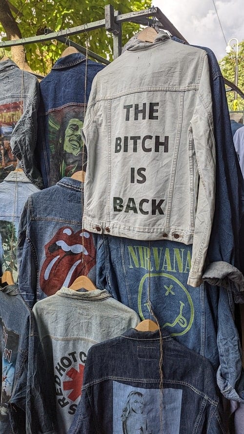 vintage denim jackets with one that says the bitch is back at portobello road market in london