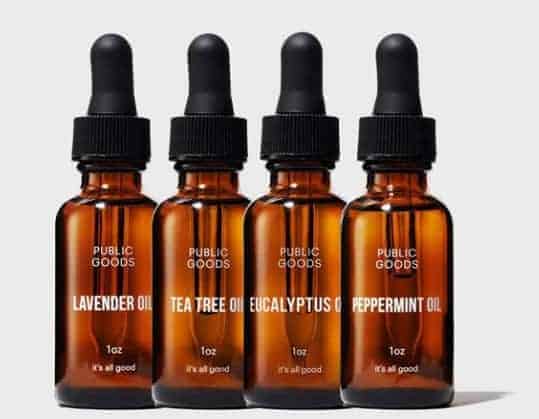 four brown bottles of essential oils from the brand public goods