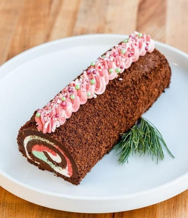 vegan chocolate swiss cake roll topped with white frosting and peppermint candies from wholesome bakery in san Francisco 