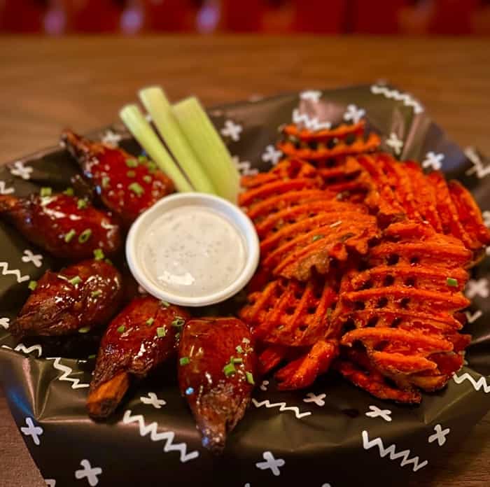 a basket of vegan wingz next to sweet potato waffle fries from the baby ketten klub in portland