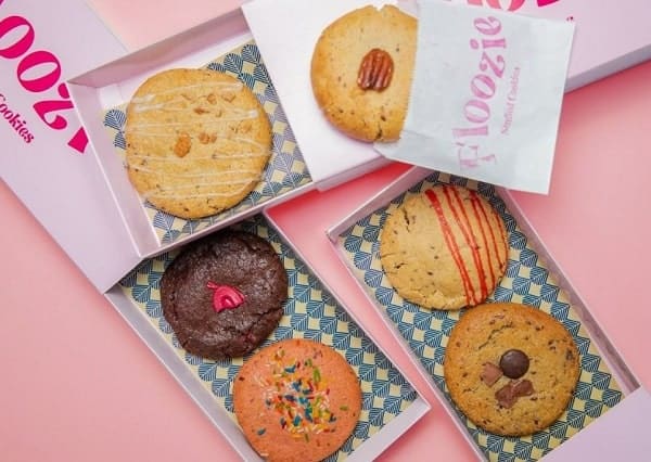three boxes of six vegan stuffed cookies on a  pink background from floozie in london