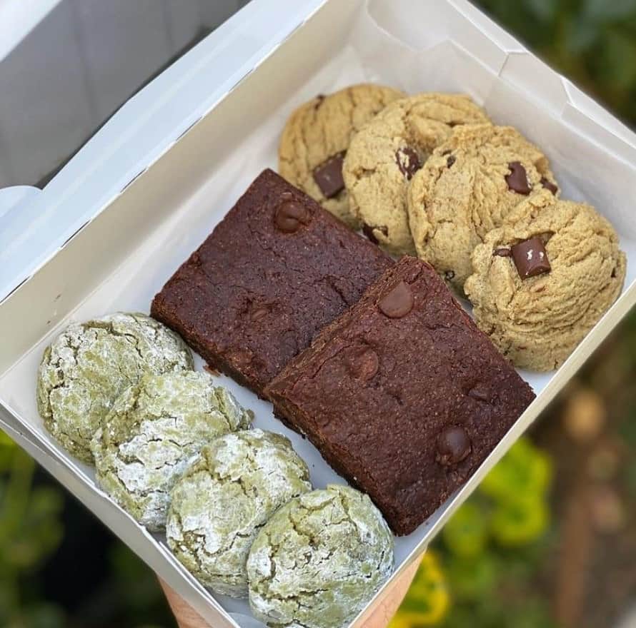a white pastry box filled with vegan cookies and brownies from the moody vegan in LA