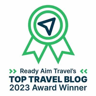 green and blue logo for ready aim travel top travel blog award winner 2023