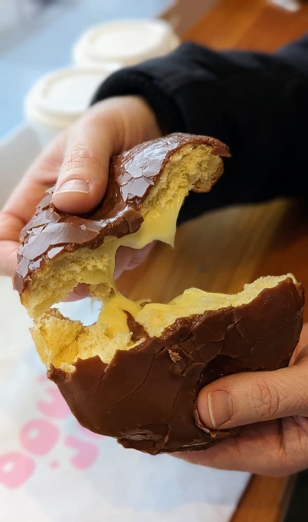 the inside of a vegan custard donut being pulled apart at dough joy in seattle