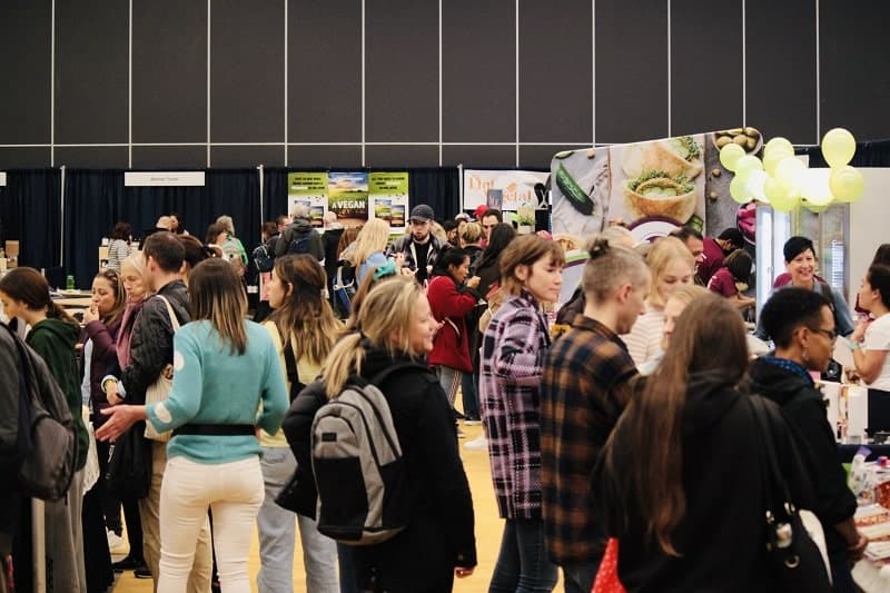 a crowded room of people at the montreal vegan food festival in canada