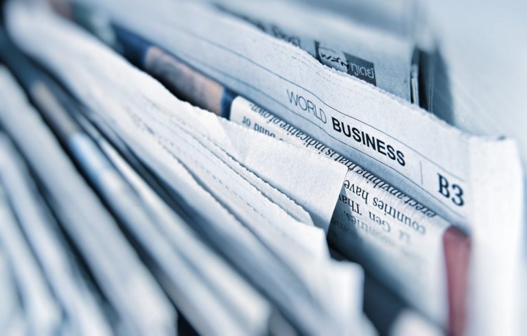 stack of black and white newspapers