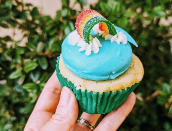 vegan vanilla cupcake topped with blue butter cream and a candy rainbow from sticky fingers in washington dc