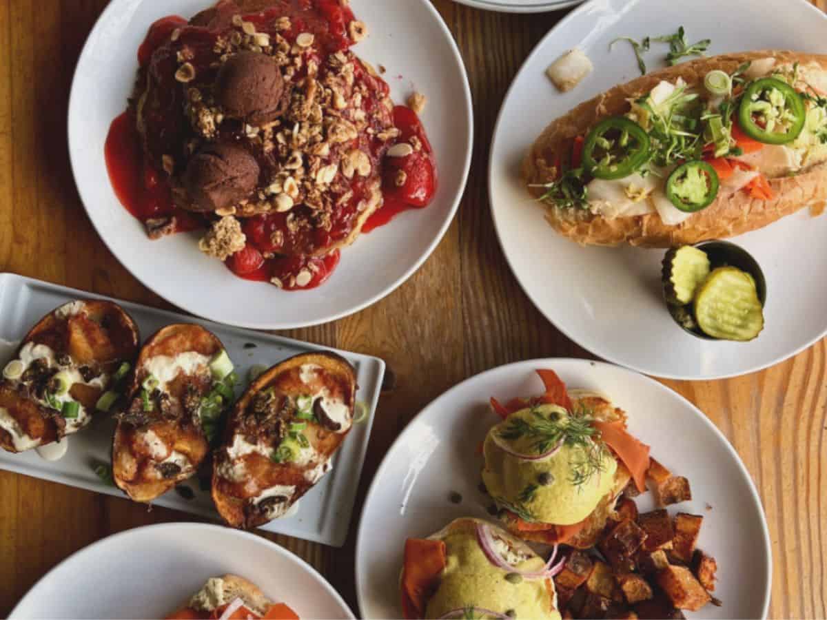 spread of vegan dishes across a light wood table in philadelphia