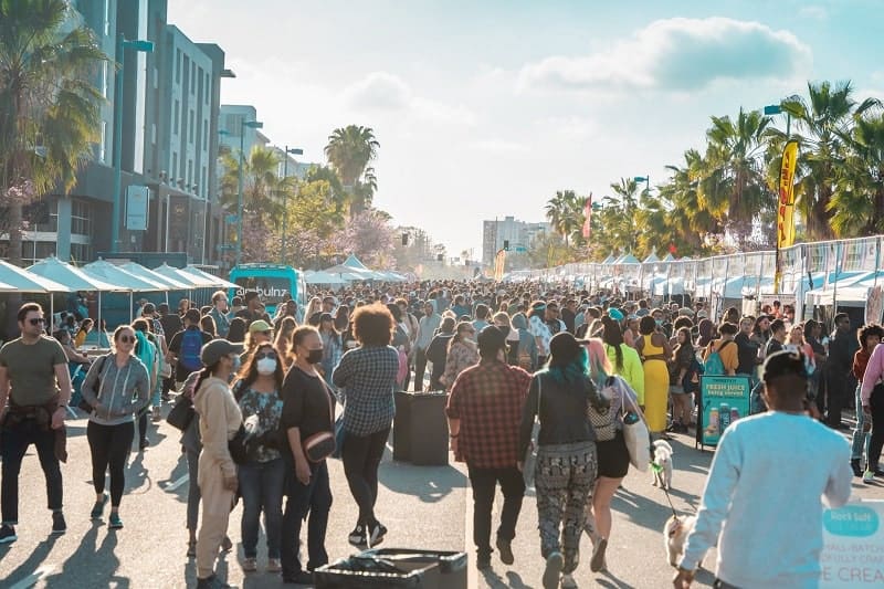 An LA street packed with people and lined with vegan vendors at one of the vegan street fair events