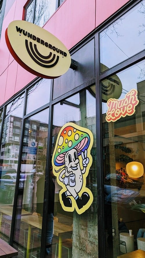 the entrance to the adaptogenic coffee shop wunderground with a colorful mushroom on the window in seattle