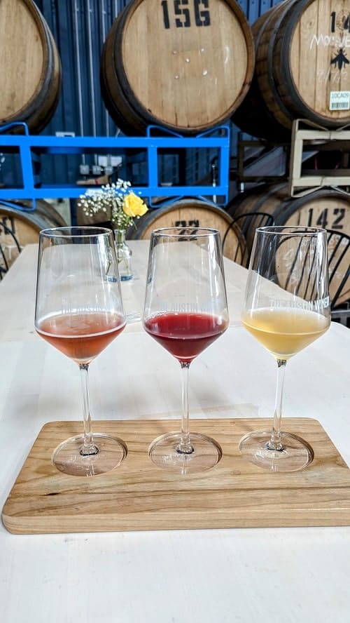 a lineup of three wine glasses filled with a small portion of wine at austin winery