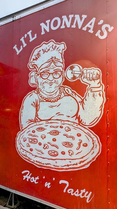 the outside of the red vegan pizza truck lil nonnas in austin