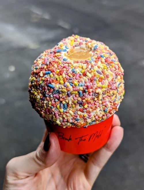 vegan soft serve ice cream covered in colorful sprinkles and filled with peanut butter in the middle from whipped urban desserts in nyc