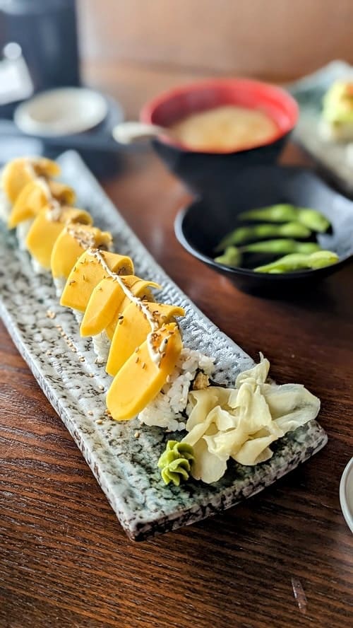 vegan dragon roll topped with mango ogenki sushi in vancouver