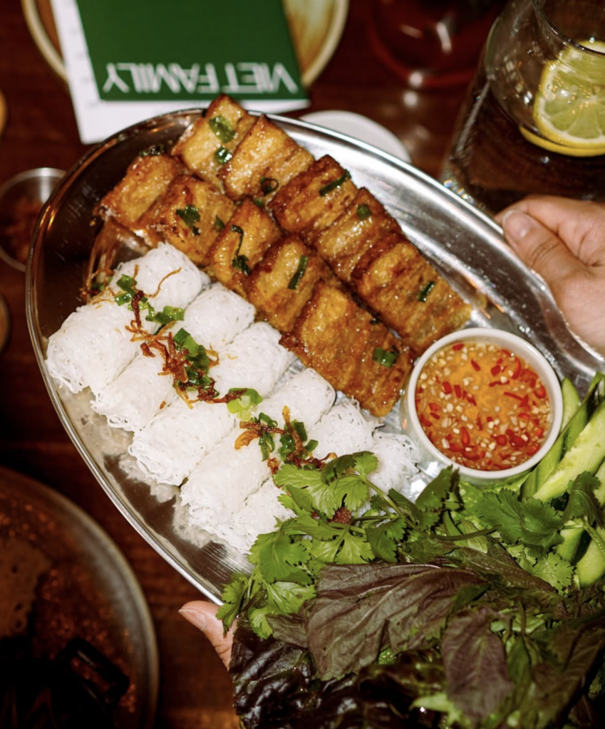Vegan Vietnamese platter at Viet Family Vancouver with rice noodles, crispy tofu, fresh herbs, and dipping sauce.