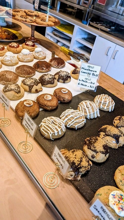 a lineup of vegan cookies behind a glass dessert case at bonus bakery in downtown vancouver