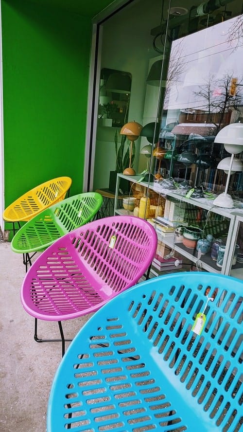 a lineup of colorful outdoor chairs on main street in vancouver