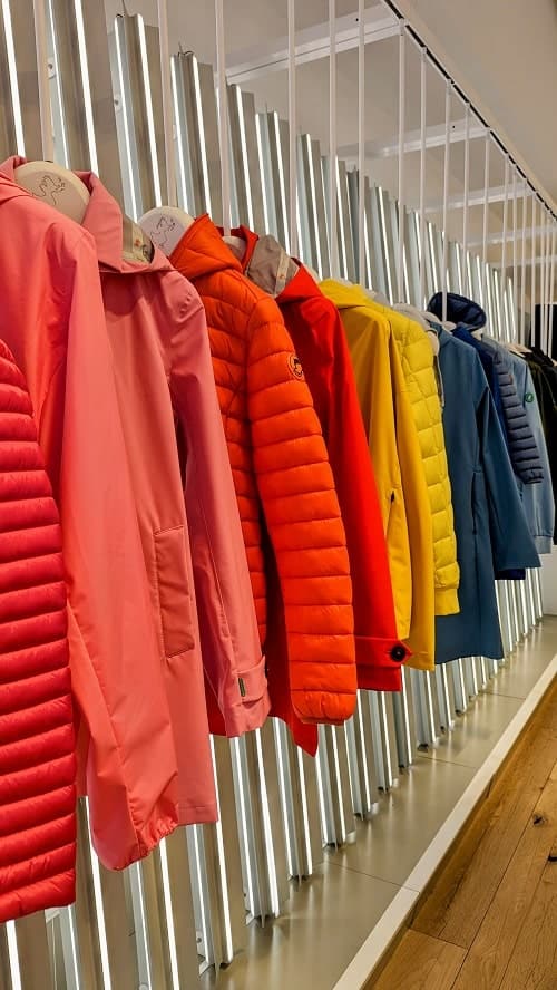 lineup of colorful vegan jackets at the vegan clothing shop save the duck in nyc