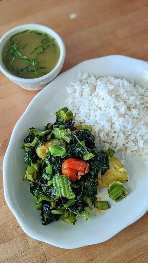 healthy vegan spinach and potato dish next to white rice at himal chuli in madison