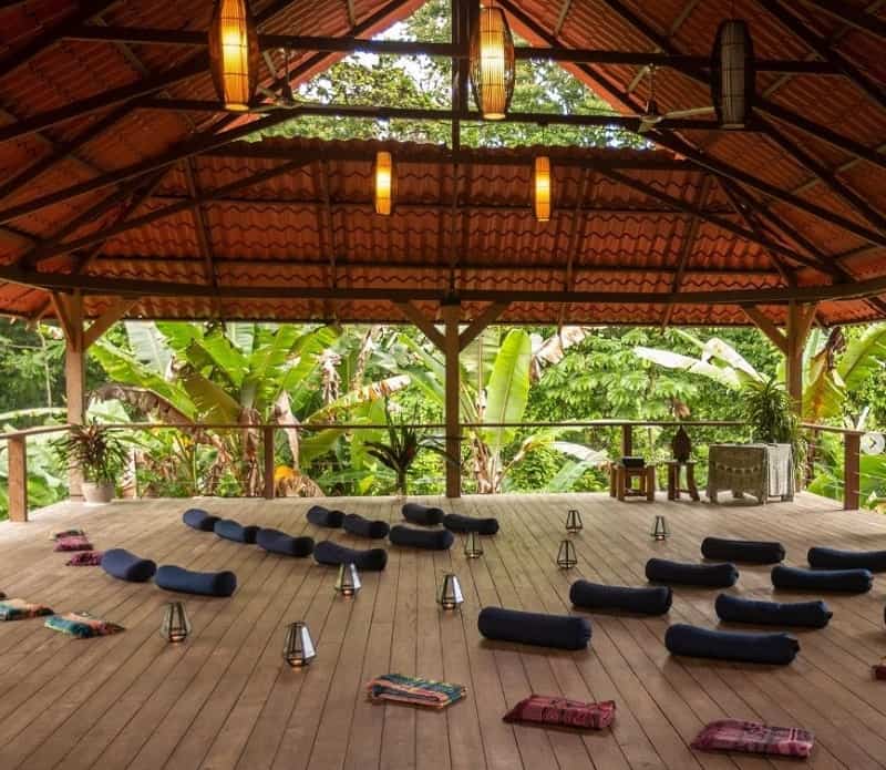 a large empty yoga room with mats laying on the floor at amaser in costa rica