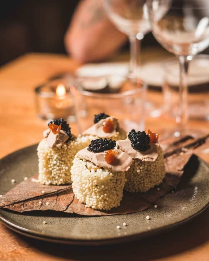 creative vegan sushi rolls covered with seeds and topped with fish less caviar in paris