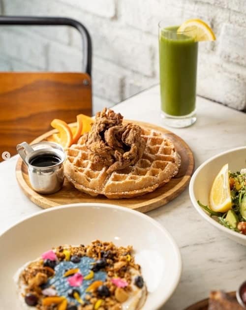 vegan brunch spread with an acai bowl and waffles at cafe gratitude in LA