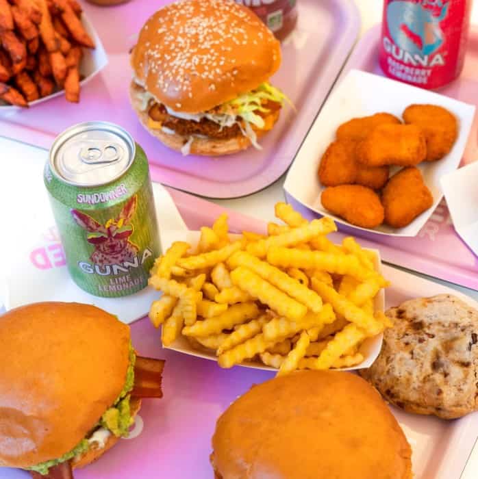 a spread of vegan junk food - burgers, chick'n nuggets, sweet potato and regular french fries in paris