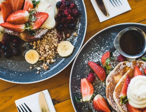 two plates of vegan pancakes side by side for breakfast in LA