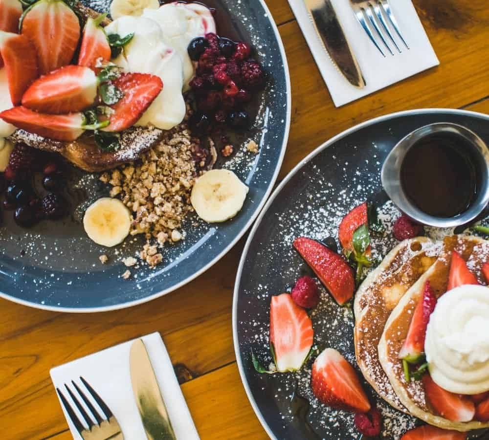 two plates of vegan pancakes side by side for breakfast in LA