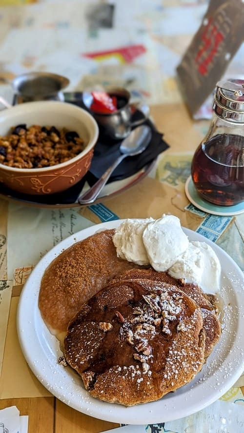 vegan pancakes covered in maple syrup next to granola at shortstack cafe in madison