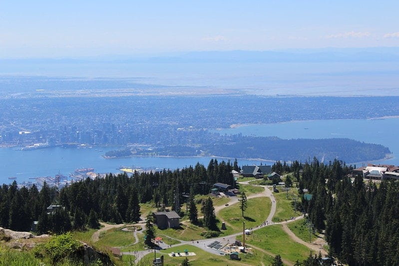 view of vancouver and the surrounding lakes from the peak of grouse mountain during the summer