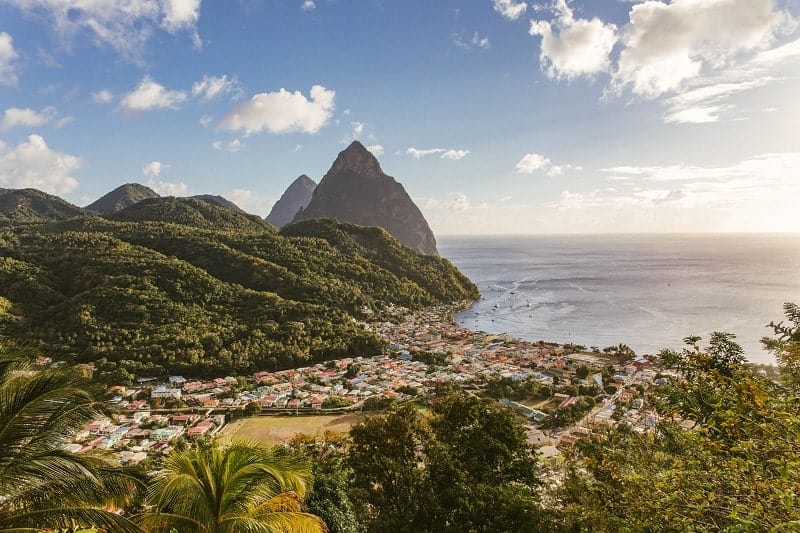 view of iconic pitons in st lucia as the sun is rising