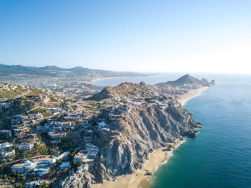 over head view of cabo san lucas surrounded by the turquoise ocean  