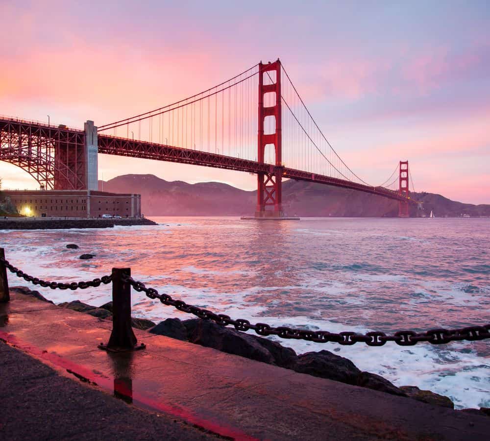 golden gate bridge at sunset with a pink and purple sky in san francisco