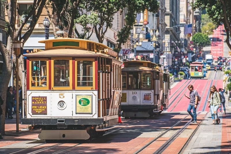 famous san francisco cable cars going up the street during a one day visit