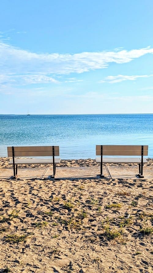two empty benches on the sleeping bear national lakeshore early in the morning