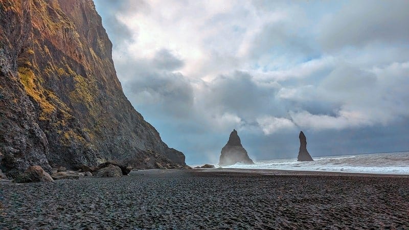 the dangerous Reynisfjara Beach on a cloudy and windy day in iceland on a day trip from Reykjavik