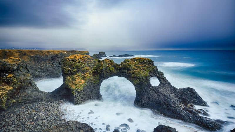 the natural black stone and green moss covered stone bridge in the Snæfellsnes Peninsula  in iceland 
