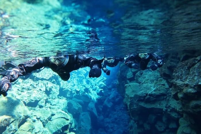 snorkeling in the silfra fissure in icelands national park on a day trip from Reykjavik 