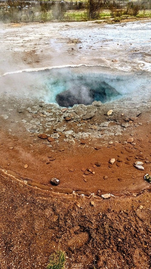blue geo thermal pool at the geysir area on iceland's golden circle on a day trip from Reykjavik 