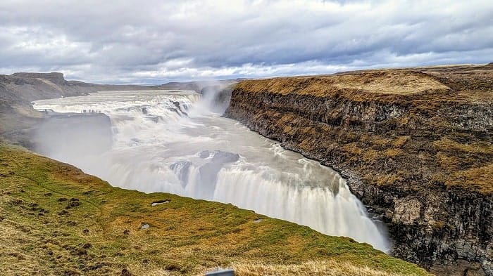 the powerful gulfoss waterfall with high water spray on a cloudy day in iceland