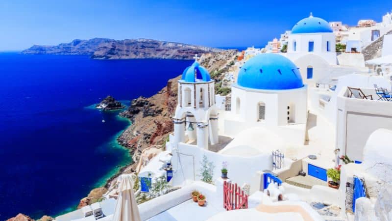 white buildings with blue domes in santorini greece