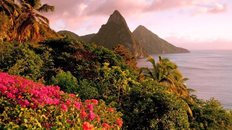 the iconic pitons surrounded by the ocean at dusk in st lucia