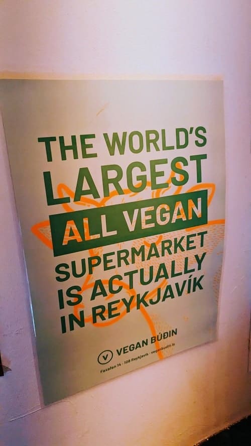 pink sign with green writing for the largest vegan market in Reykjavik