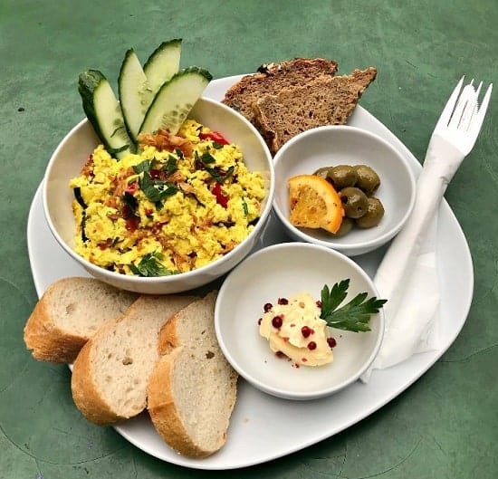 vegan tofu scramble with toast and veggies on a green table at cafe morgenrot at brunch in berlin