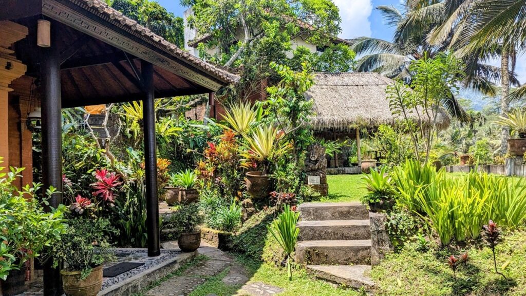 a rustic pathway through lush greenery at the vegan friendly hotel cepik villa in sidemen bali