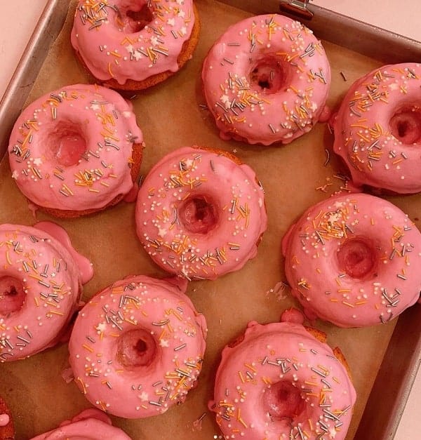 pink frosted vegan cake donuts topped with sprinkles at erin mckenna's bakery in los angeles