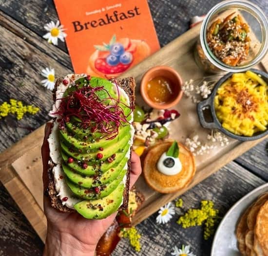 vegan brunch platter with avocado toast, pancakes, and tofu scramble at froindlichst in berlin
