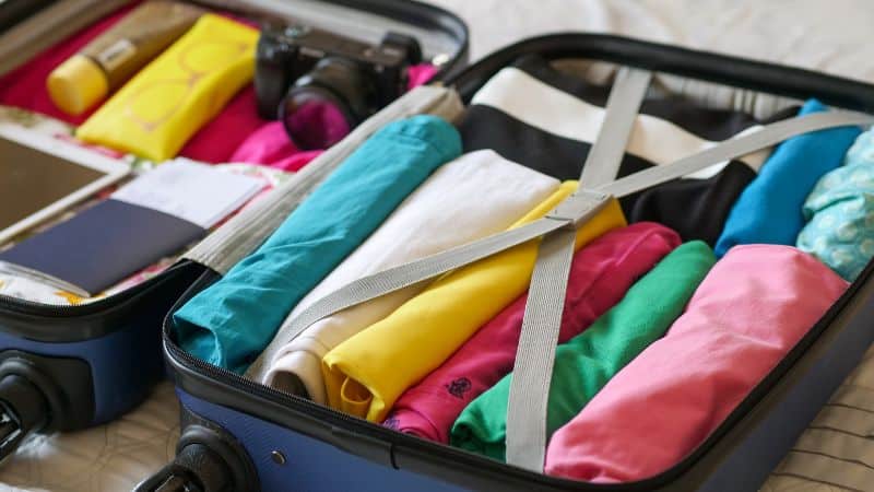 clothes rolled tightly in a carry on suitcase to save space